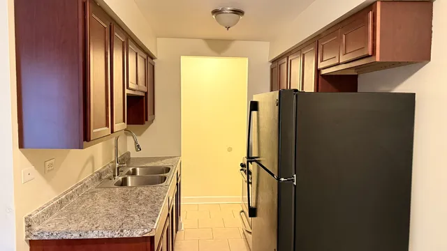 a bathroom with a granite countertop shower a sink and a mirror