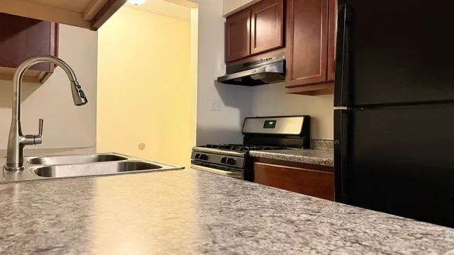 a kitchen with granite countertop a stove and a microwave