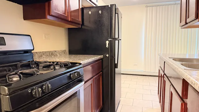 a kitchen with a stove and a refrigerator