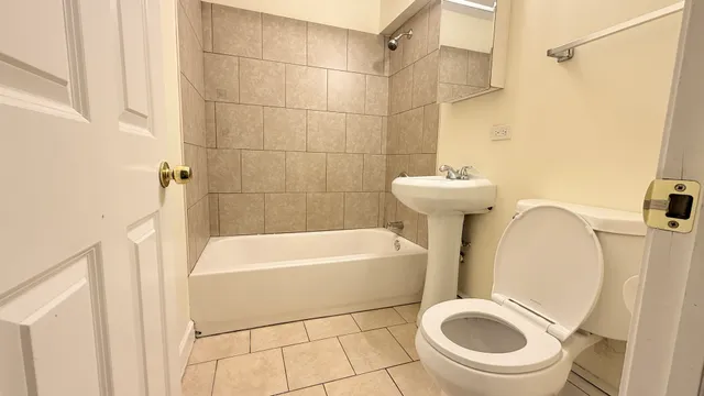 a bathroom with a sink a toilet and bathtub