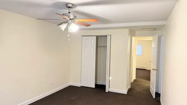 a view of a room with a sink and a chandelier fan