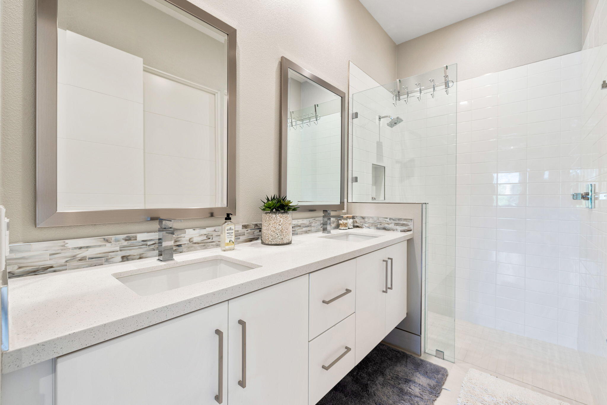 2 Iridium Way Rancho Mirage, CA 92270 - Photo 16 of 67 a bathroom with a double vanity sink and mirror