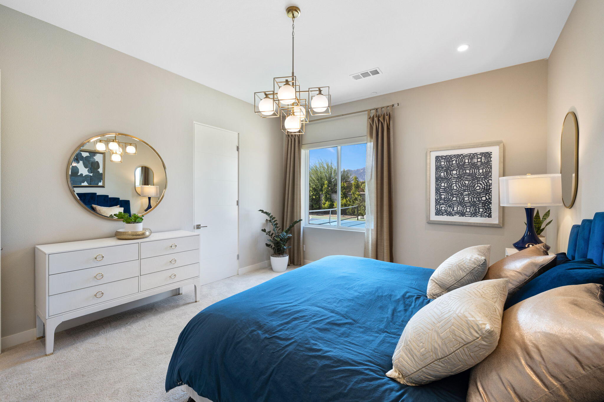 2 Iridium Way Rancho Mirage, CA 92270 - Photo 18 of 67 a spacious bedroom with a bed and a dresser