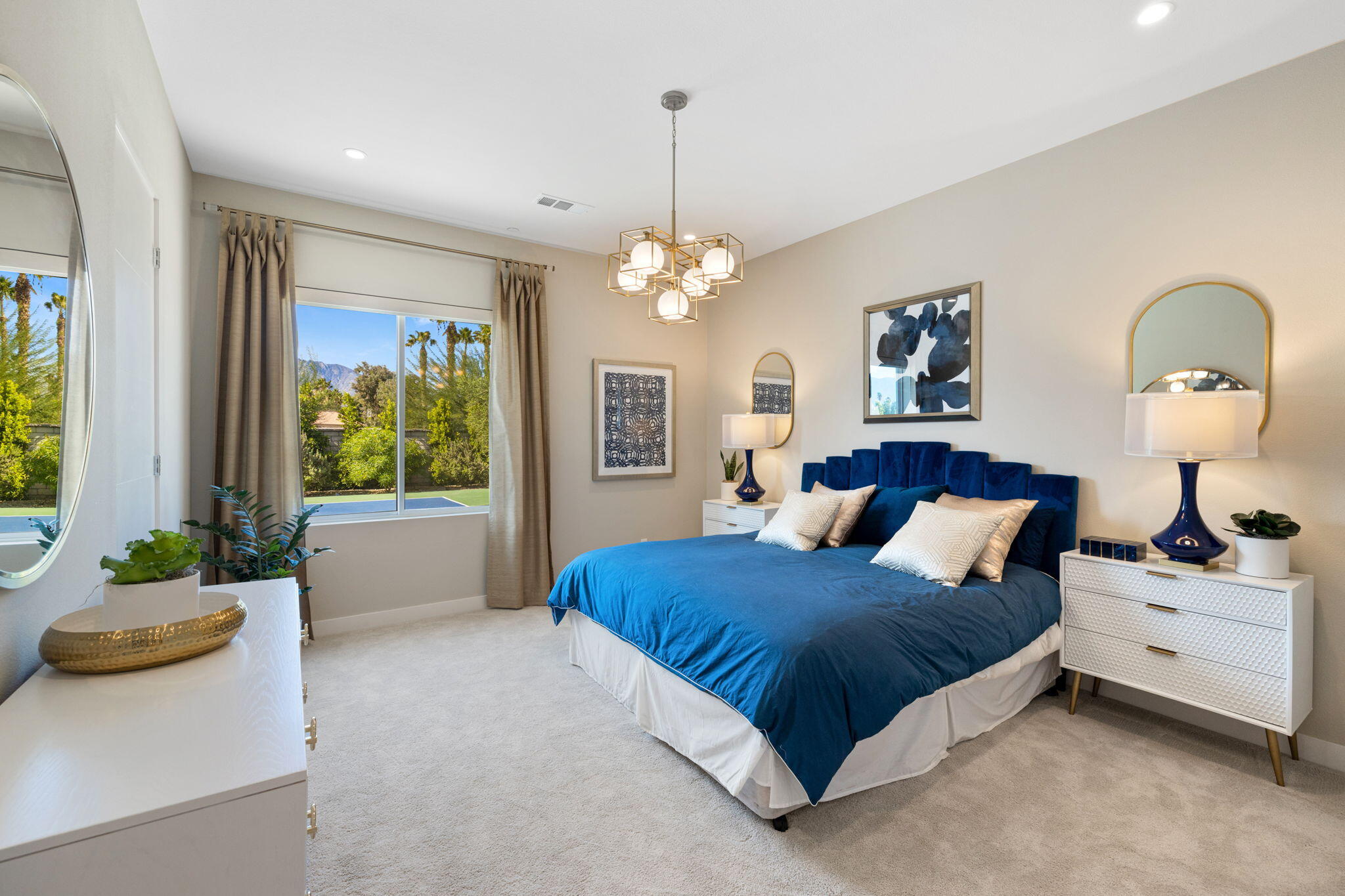 2 Iridium Way Rancho Mirage, CA 92270 - Photo 19 of 67 a bedroom with a bed and a chandelier