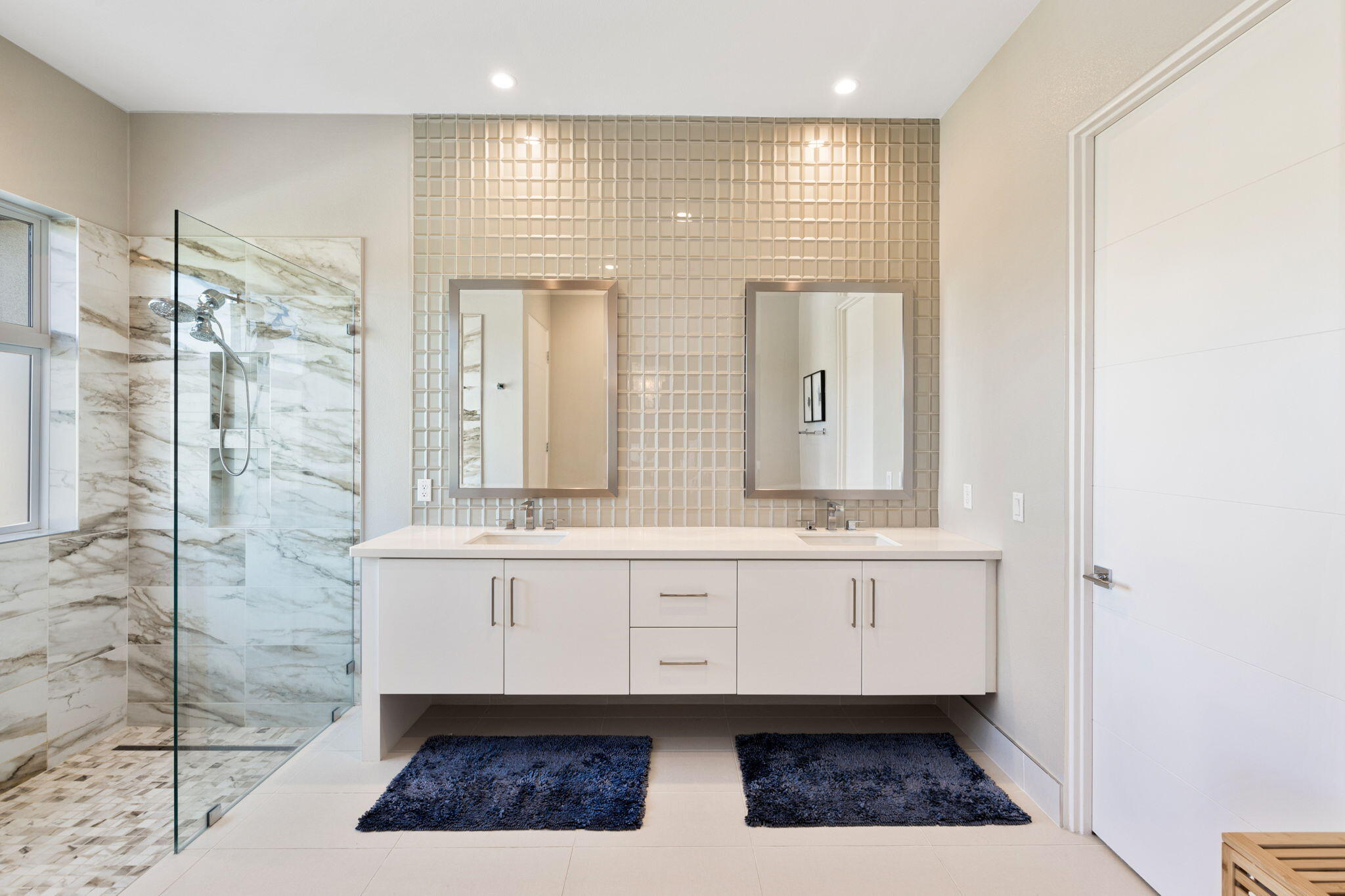 2 Iridium Way Rancho Mirage, CA 92270 - Photo 21 of 67 a bathroom with a double vanity sink a mirror and a shower