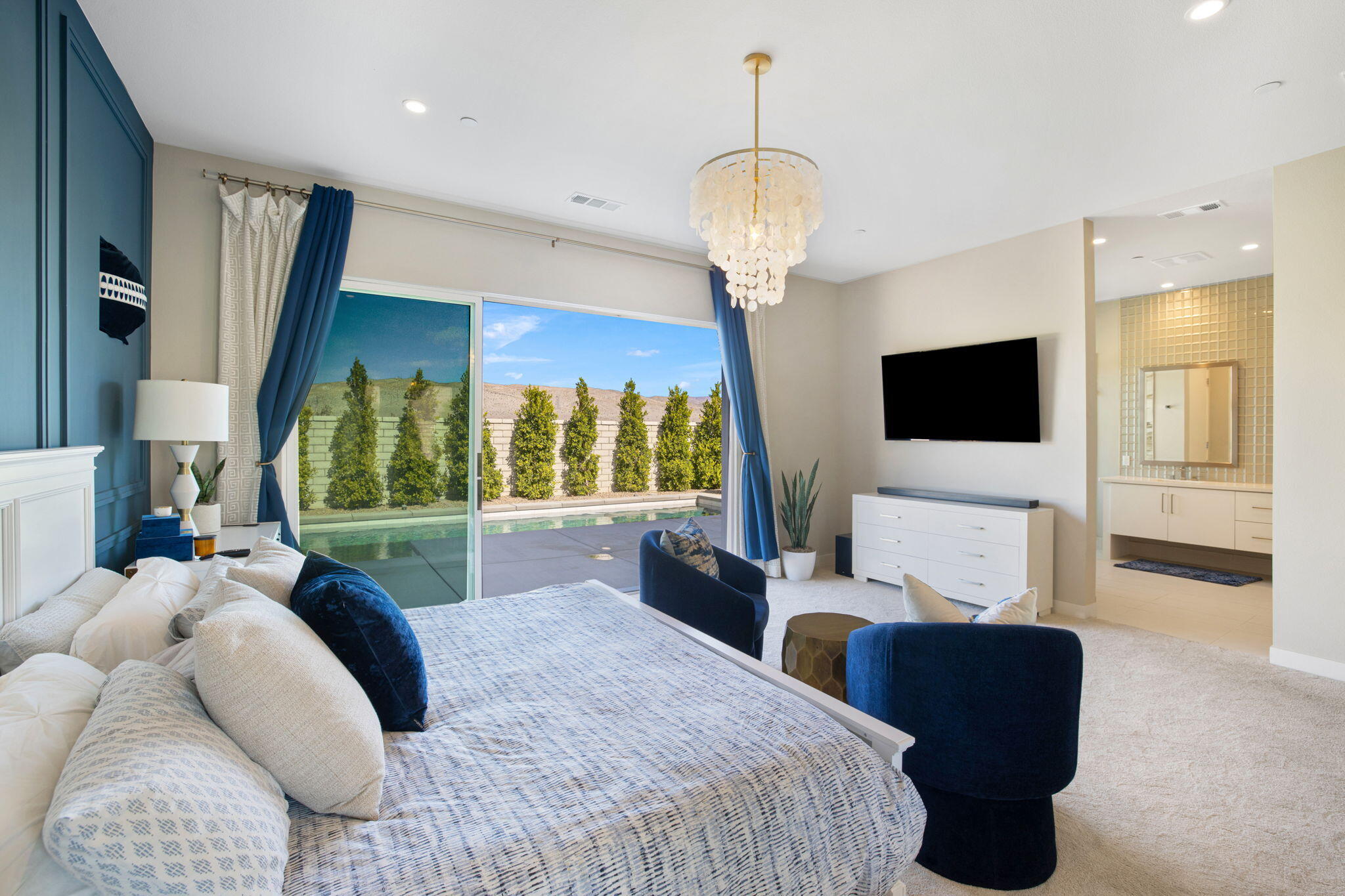 2 Iridium Way Rancho Mirage, CA 92270 - Photo 24 of 67 a bedroom with a bed a window and a chandelier