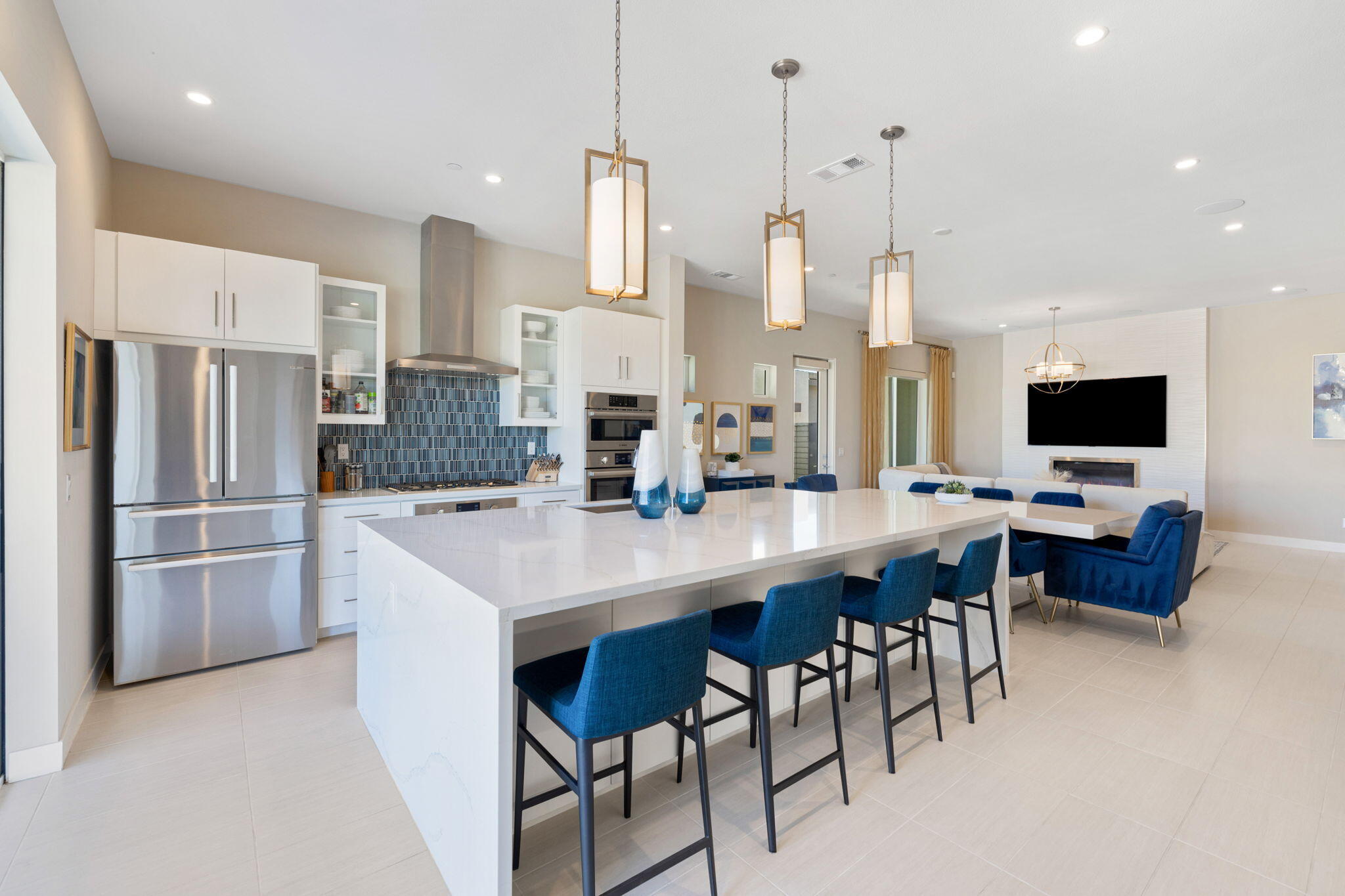 2 Iridium Way Rancho Mirage, CA 92270 - Photo 31 of 67 a kitchen with stainless steel appliances a table chairs refrigerator and microwave