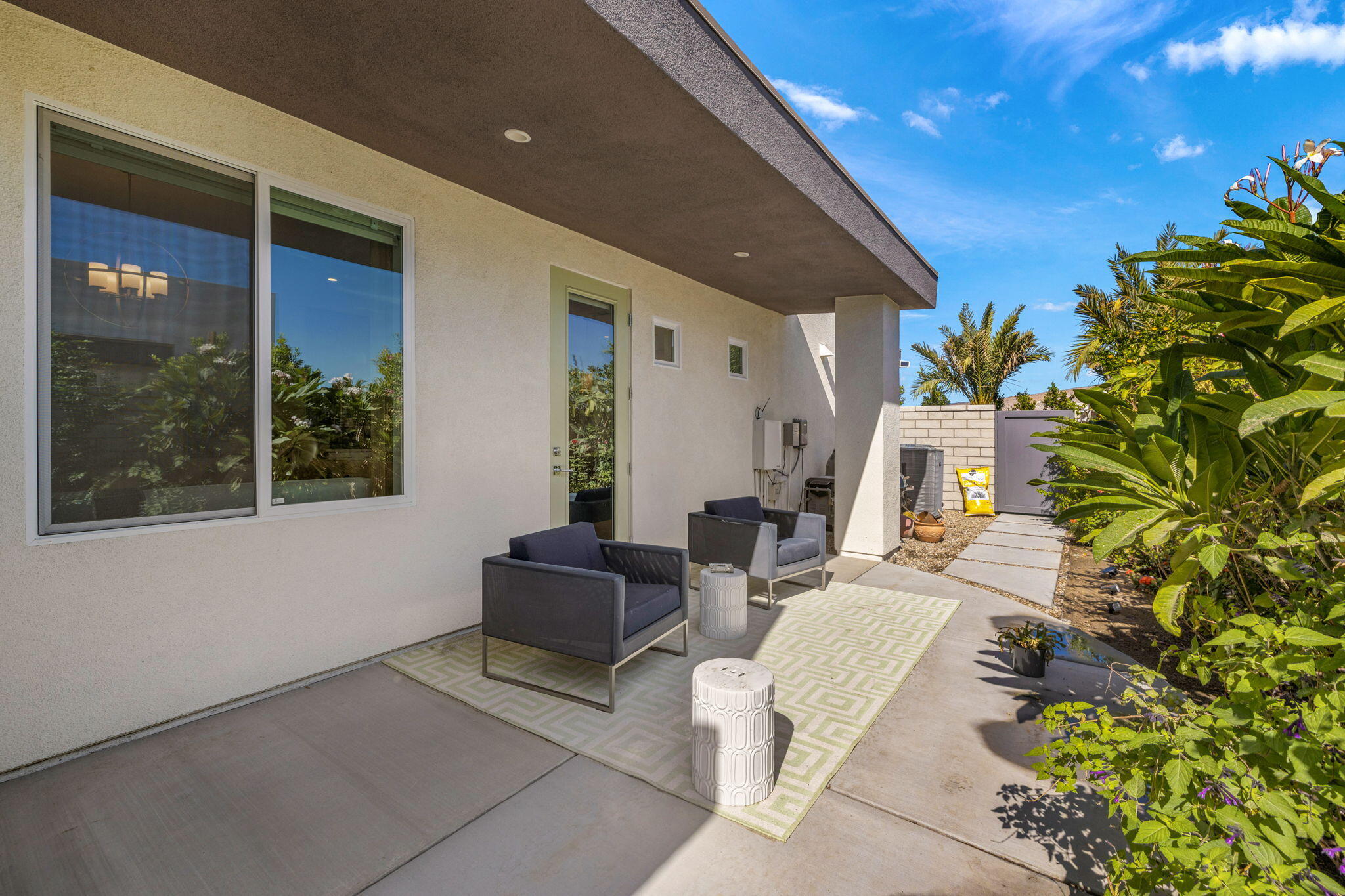 2 Iridium Way Rancho Mirage, CA 92270 - Photo 42 of 67 a living room with furniture and a potted plant