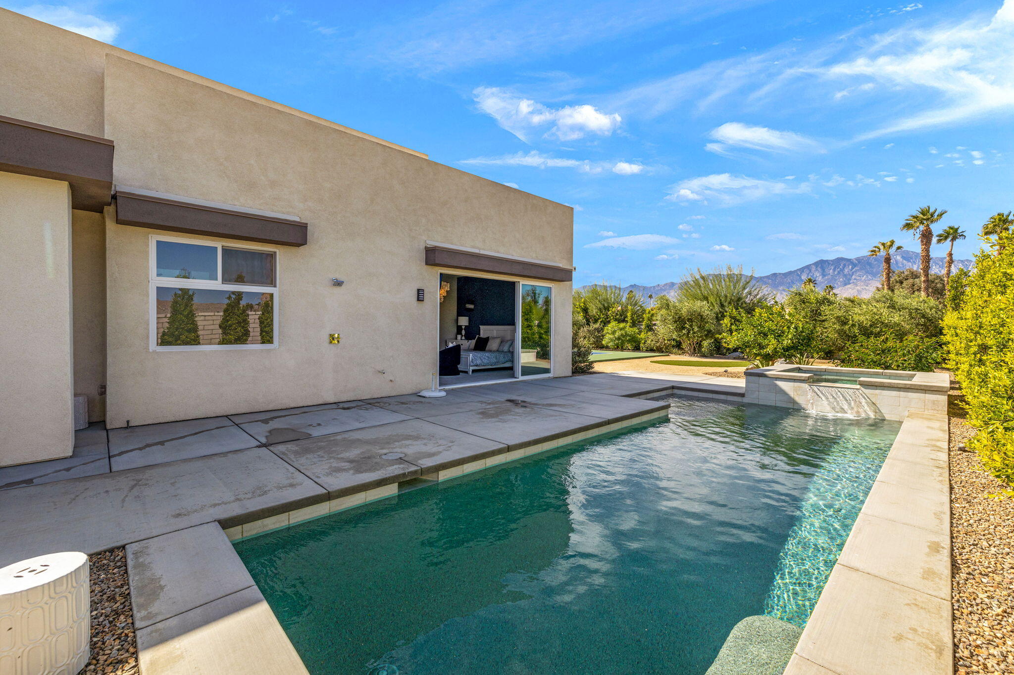 2 Iridium Way Rancho Mirage, CA 92270 - Photo 53 of 67 a view of a swimming pool with an outdoor seating