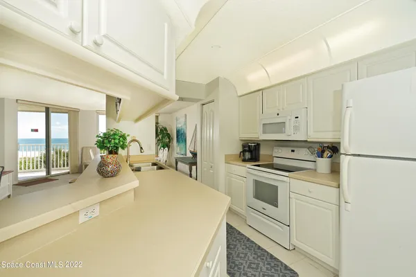 a kitchen with cabinets and stainless steel appliances