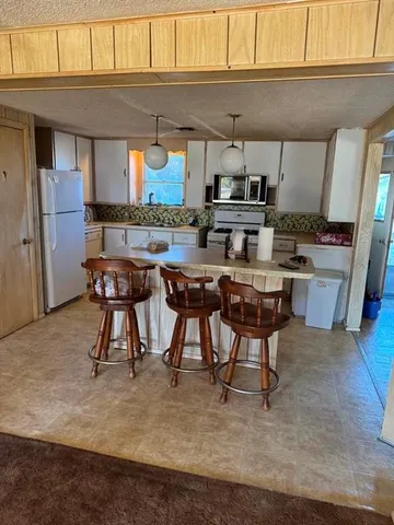 a dining room with furniture and a kitchen view