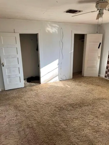 a bed sitting in a room next to a blue wall