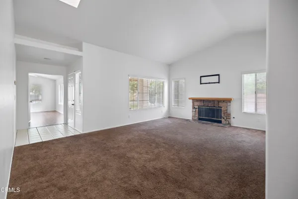 a view of empty room with a fireplace