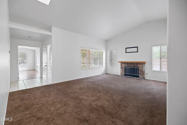 a view of empty room with a fireplace