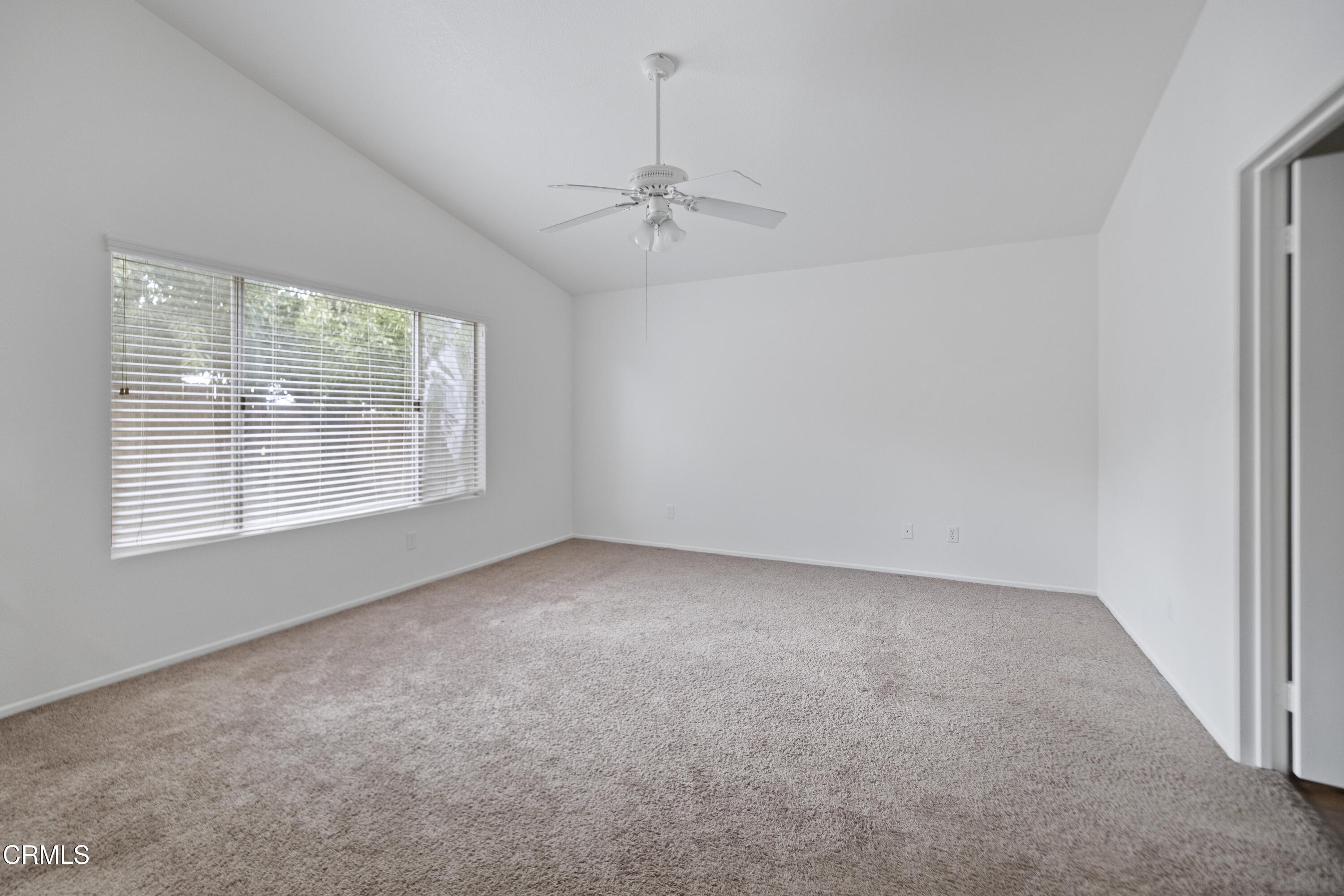 15589 Cheyenne Street Hesperia, CA 92345 - Photo 6 of 12 en empty room with windows and ceiling fan