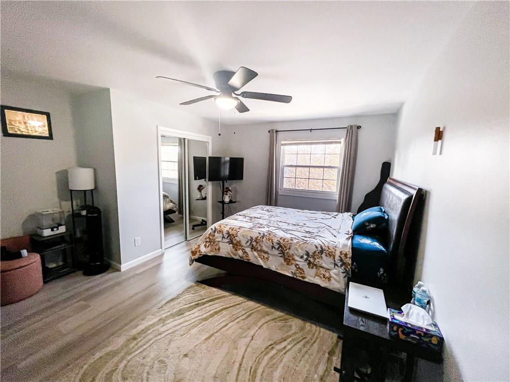 3549 Old Chamblee Tucker Road, Unit J Atlanta, GA 30340 - Photo 16 of 61 a bedroom with a bed and wooden floor