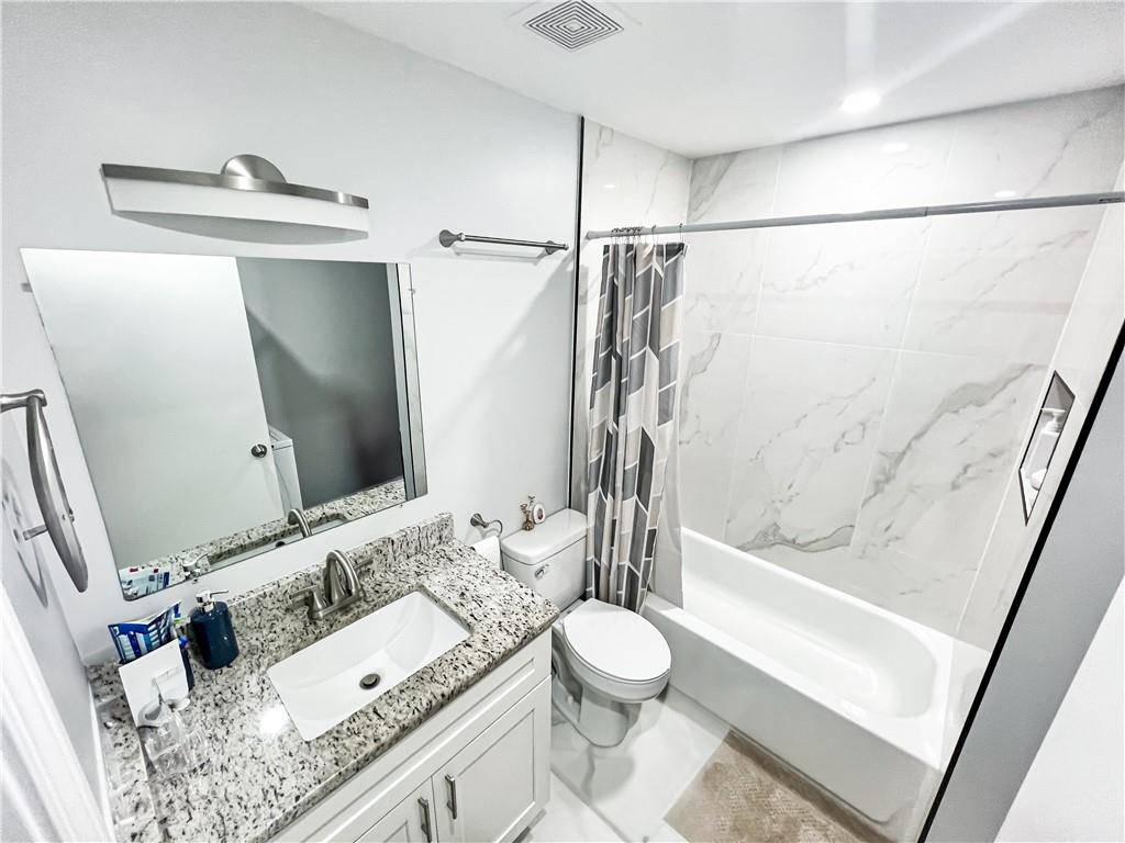 3549 Old Chamblee Tucker Road, Unit J Atlanta, GA 30340 - Photo 17 of 61 a bathroom with a granite countertop sink toilet and shower