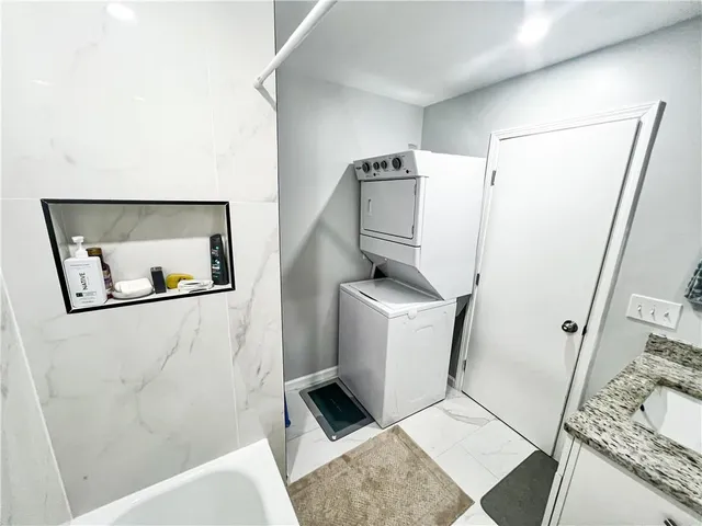 a bathroom with a granite countertop sink a toilet and a bathtub