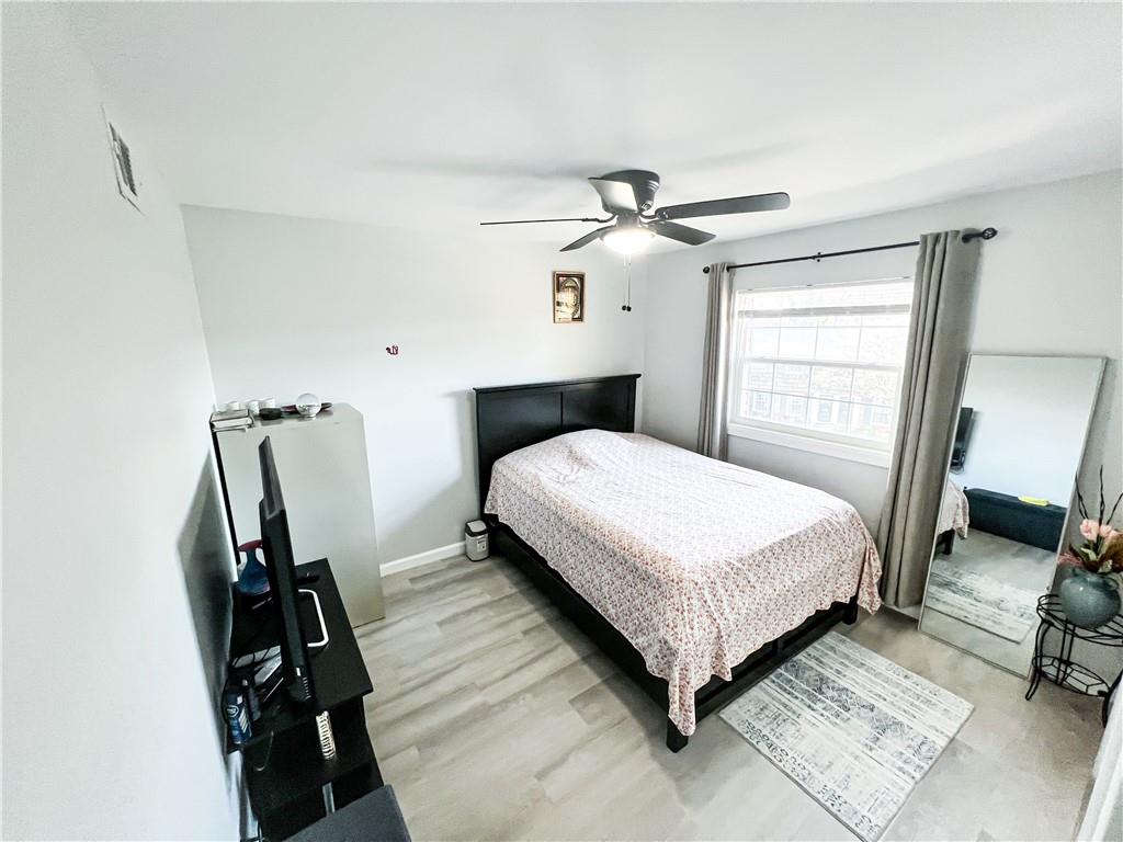 3549 Old Chamblee Tucker Road, Unit J Atlanta, GA 30340 - Photo 21 of 61 a bedroom with a bed and wooden floor