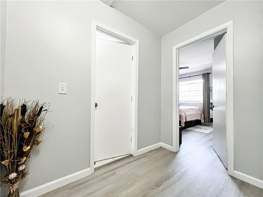 3549 Old Chamblee Tucker Road, Unit J Atlanta, GA 30340 - Photo 23 of 61 a view of a bedroom with wooden floor and a window