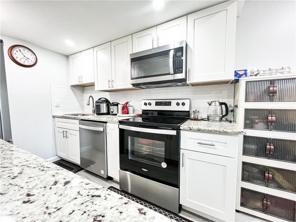 3549 Old Chamblee Tucker Road, Unit J Atlanta, GA 30340 - Photo 32 of 61 a kitchen with a stove and a microwave