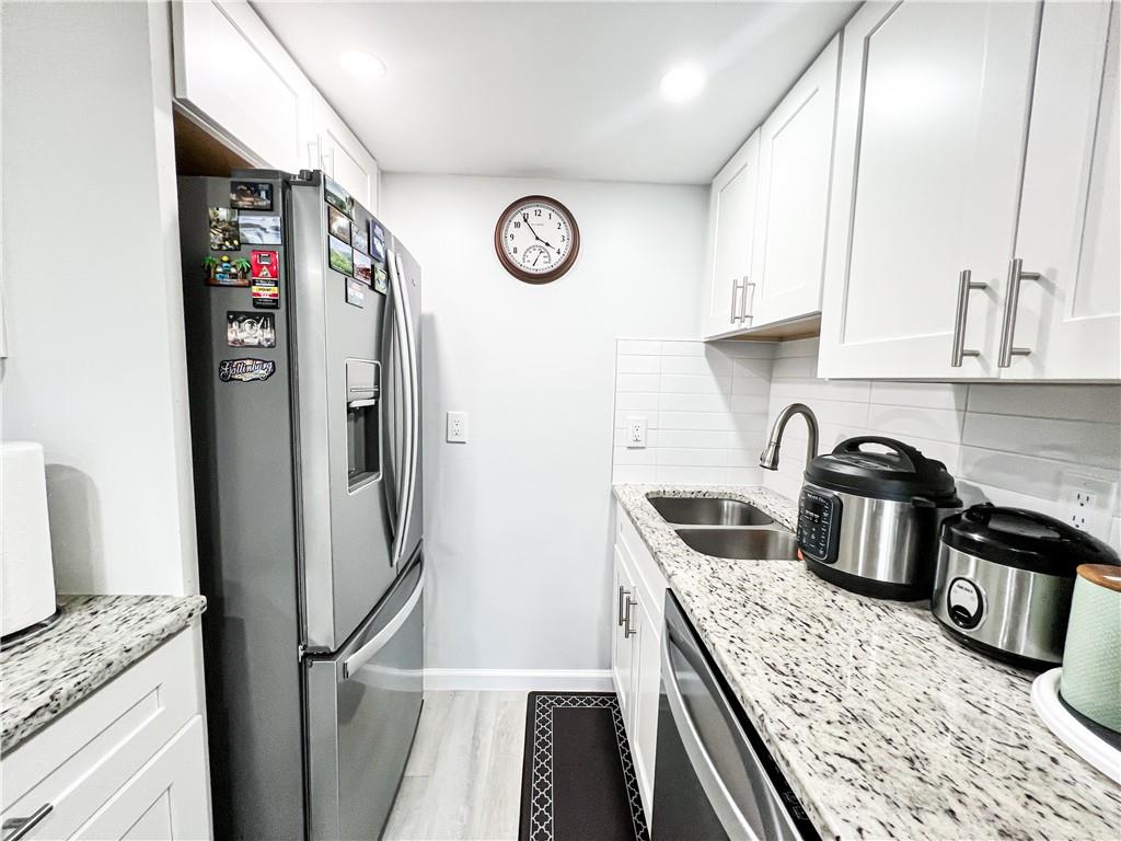 3549 Old Chamblee Tucker Road, Unit J Atlanta, GA 30340 - Photo 34 of 61 a kitchen with stainless steel appliances granite countertop a refrigerator a stove and a sink