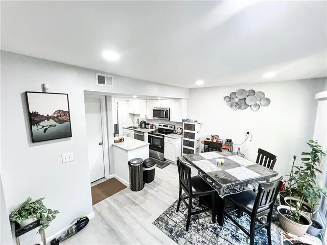 a kitchen with stainless steel appliances granite countertop a refrigerator and a stove