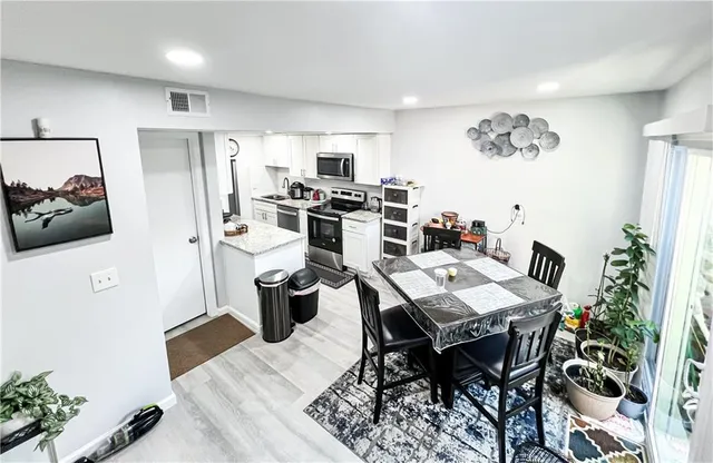 a view of a dining room with furniture window and wooden floor