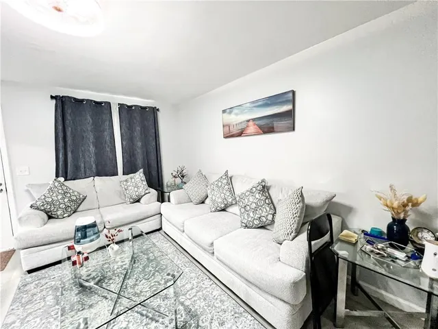 a view of a hallway with wooden floor and a potted plant