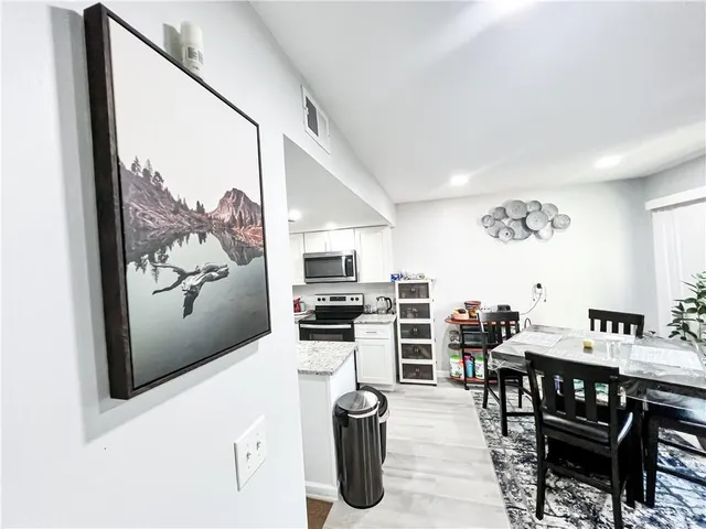 a bathroom with a granite countertop sink a toilet and a mirror