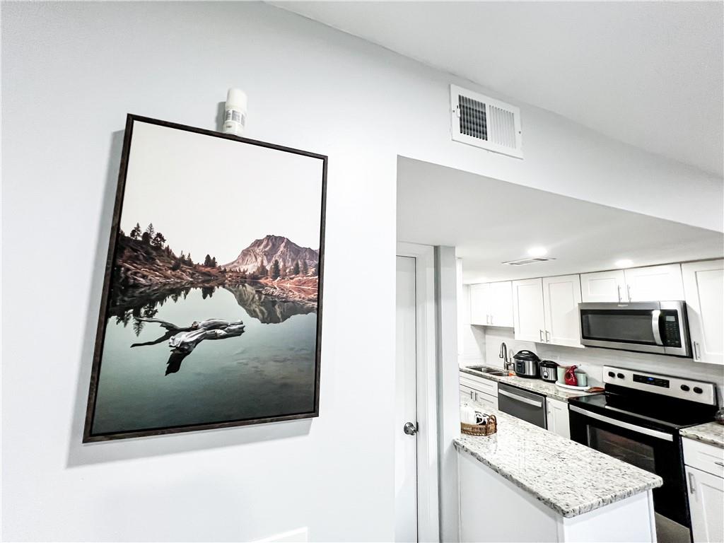 3549 Old Chamblee Tucker Road, Unit J Atlanta, GA 30340 - Photo 43 of 61 a kitchen with stainless steel appliances granite countertop a refrigerator and a stove