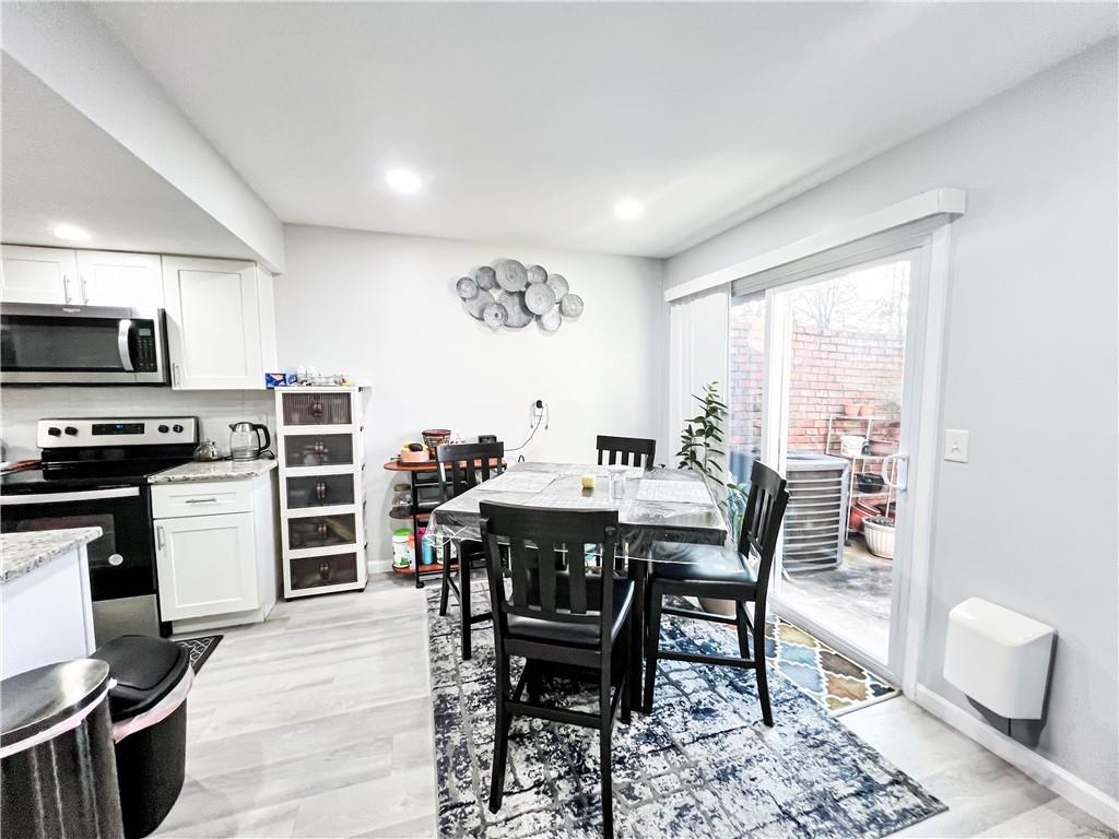 3549 Old Chamblee Tucker Road, Unit J Atlanta, GA 30340 - Photo 45 of 61 a view of a dining room with furniture window and wooden floor