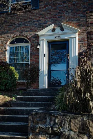 a front view of a house with plants