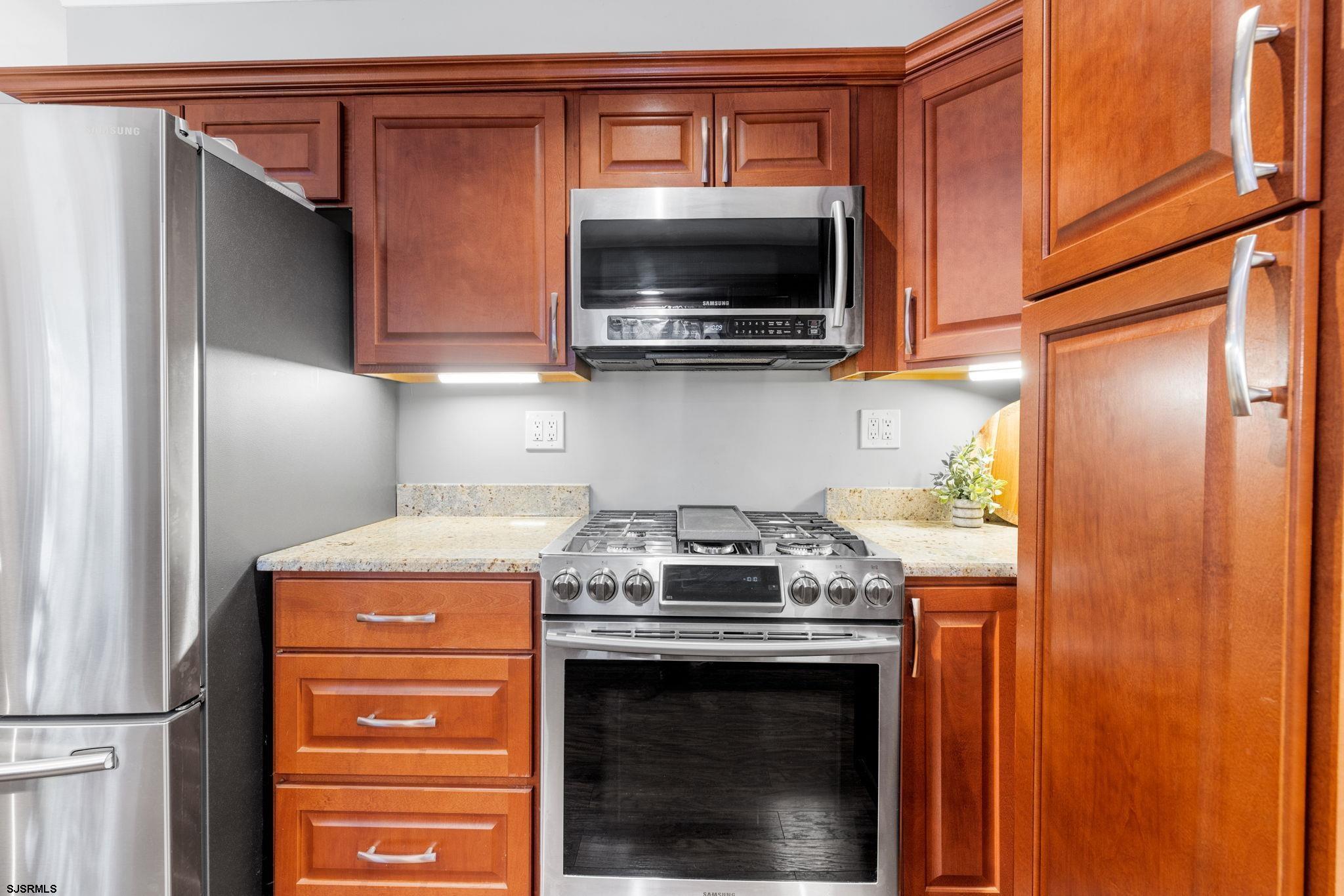 210 Mill Road Absecon, NJ 08201 - Photo 12 of 52 a kitchen with a stove and a microwave