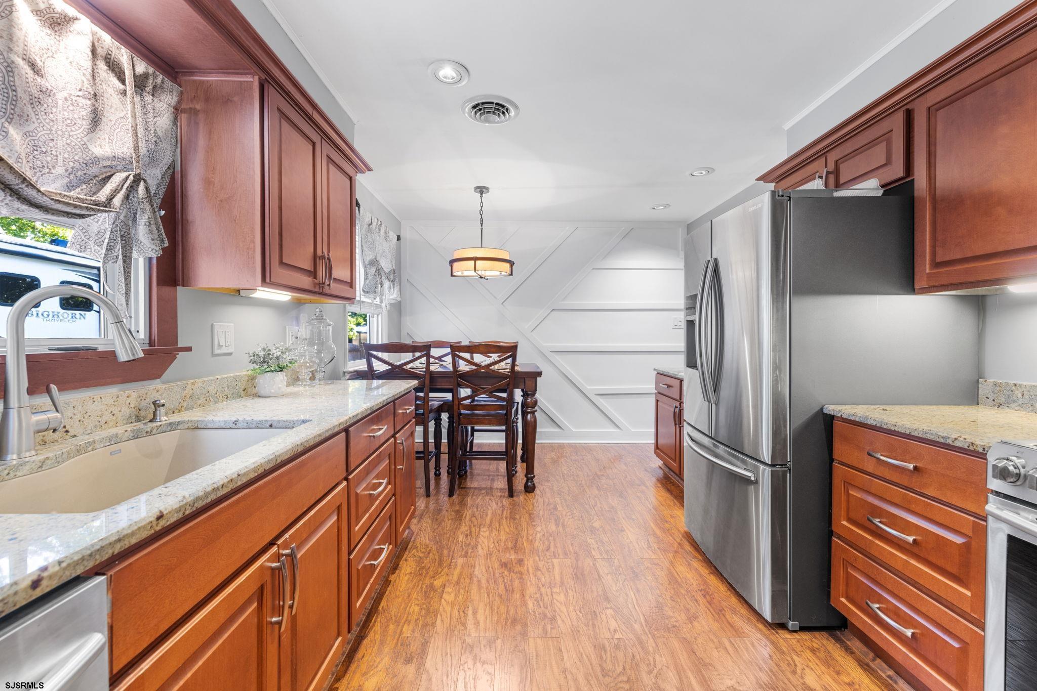 210 Mill Road Absecon, NJ 08201 - Photo 13 of 52 a kitchen with granite countertop a refrigerator stove and sink