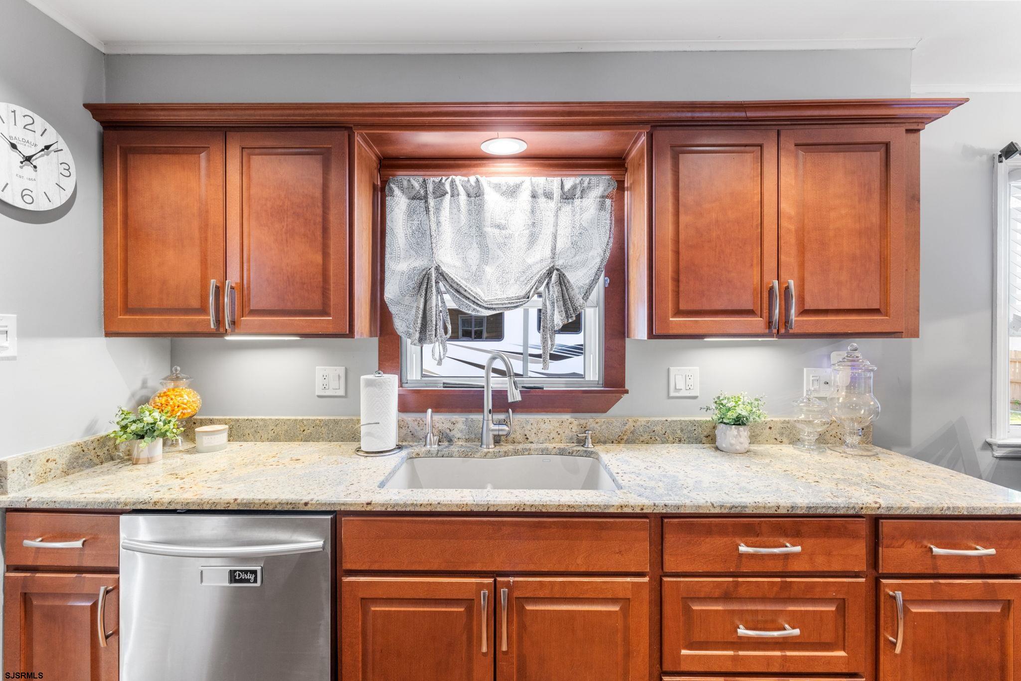 210 Mill Road Absecon, NJ 08201 - Photo 14 of 52 a kitchen with granite countertop stainless steel appliances a sink and a window
