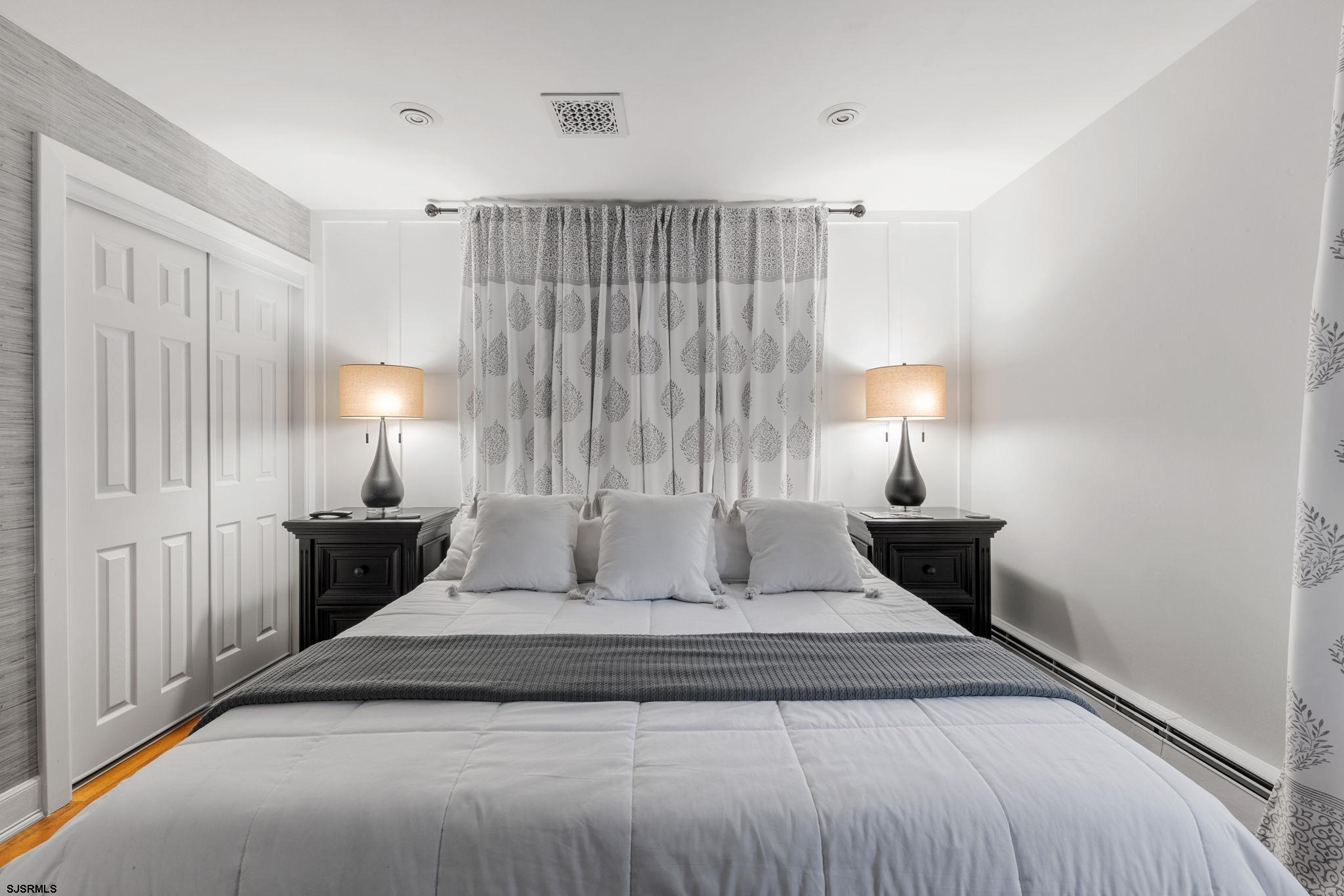 210 Mill Road Absecon, NJ 08201 - Photo 17 of 52 a bedroom with a bed and a lamp