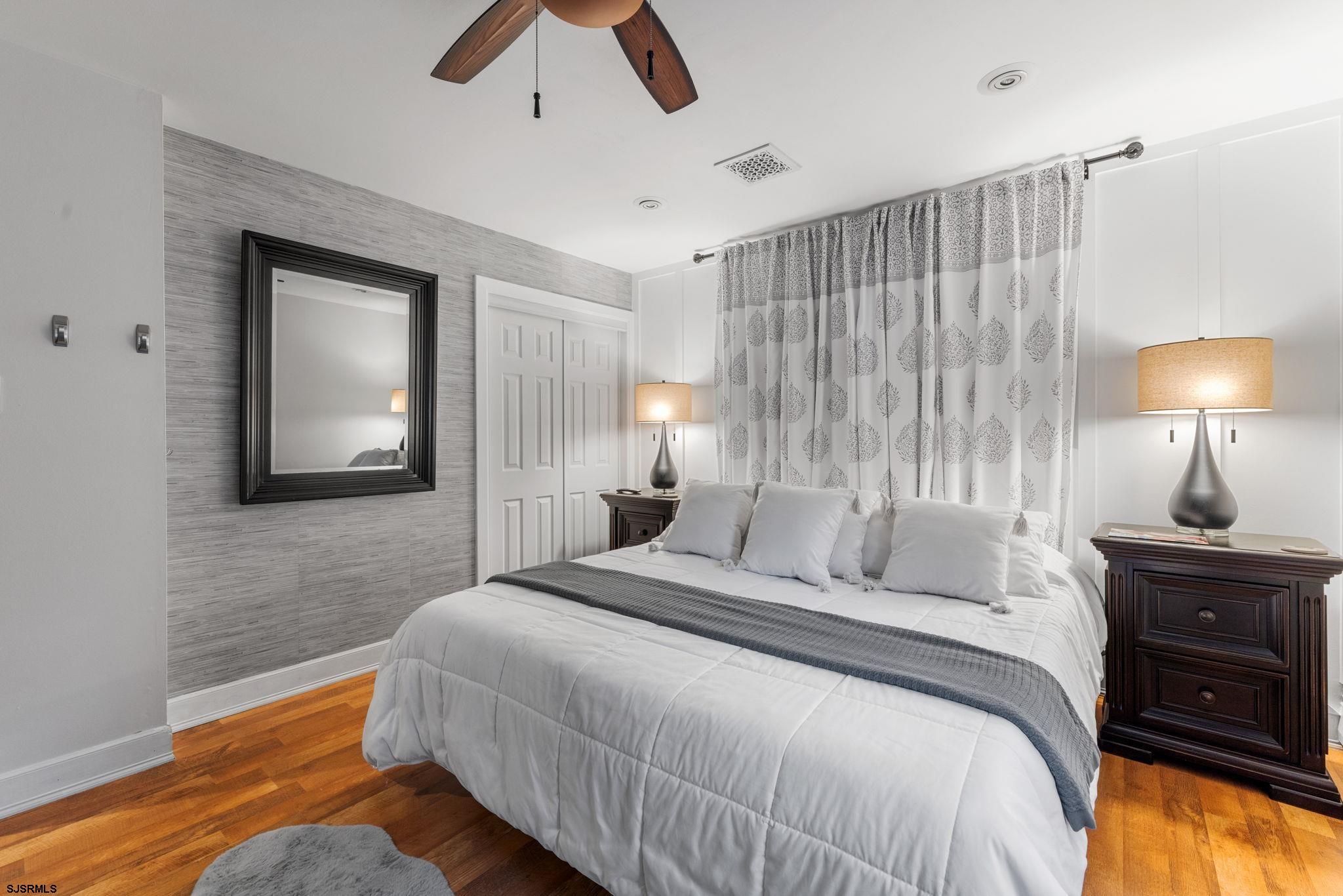 210 Mill Road Absecon, NJ 08201 - Photo 18 of 52 a bedroom with a bed and a lamp