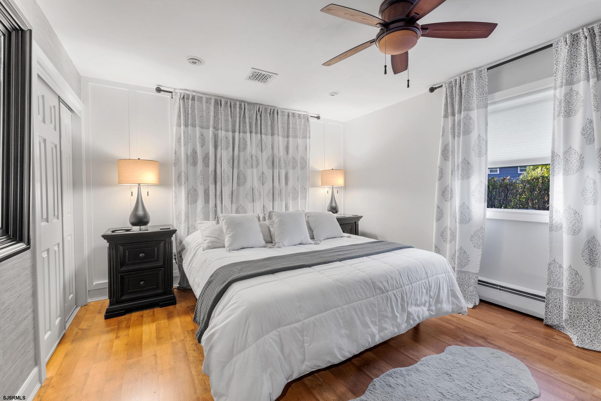 210 Mill Road Absecon, NJ 08201 - Photo 19 of 52 a bedroom with a bed and a lamp