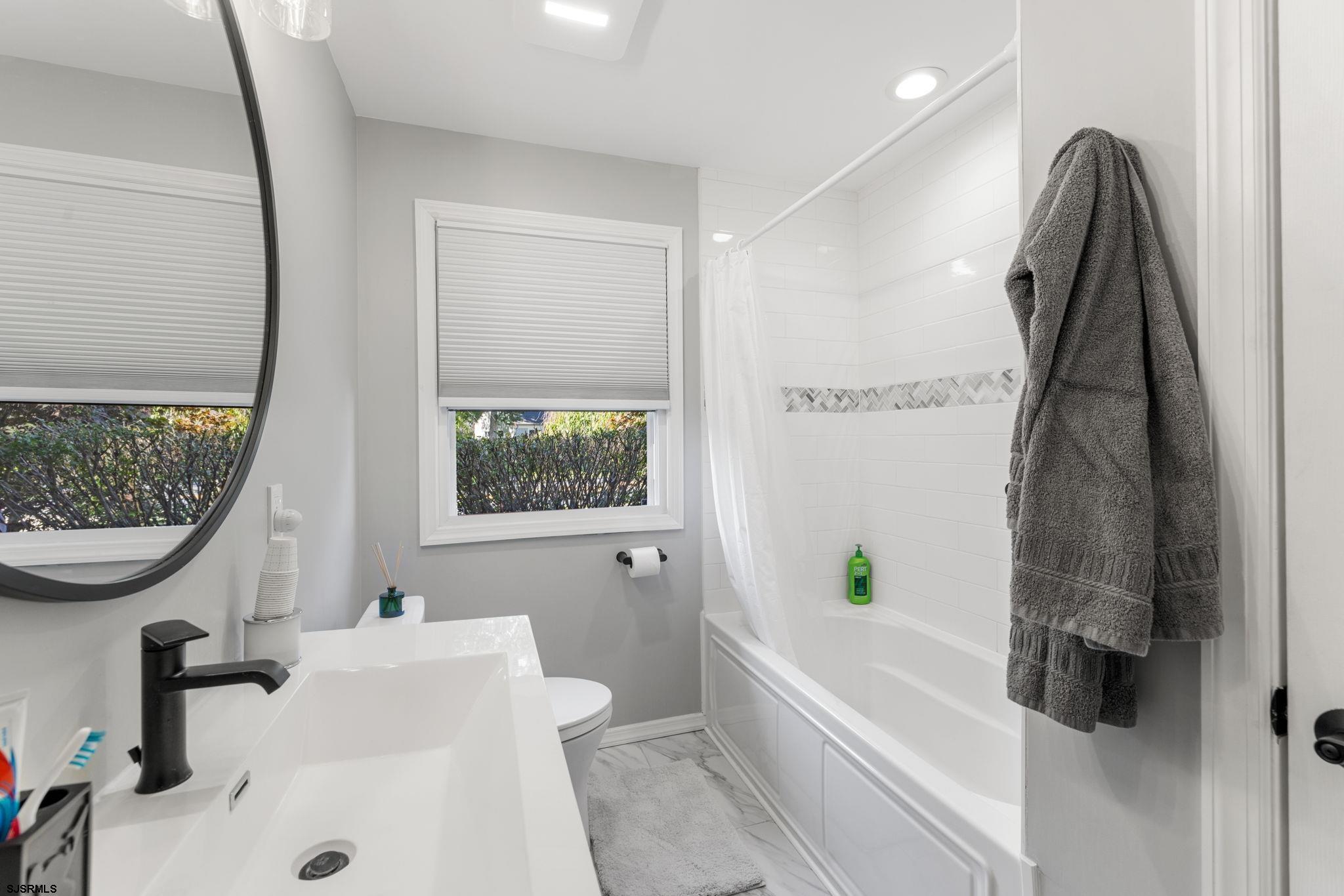 210 Mill Road Absecon, NJ 08201 - Photo 32 of 52 a bathroom with a sink a toilet and a bathtub