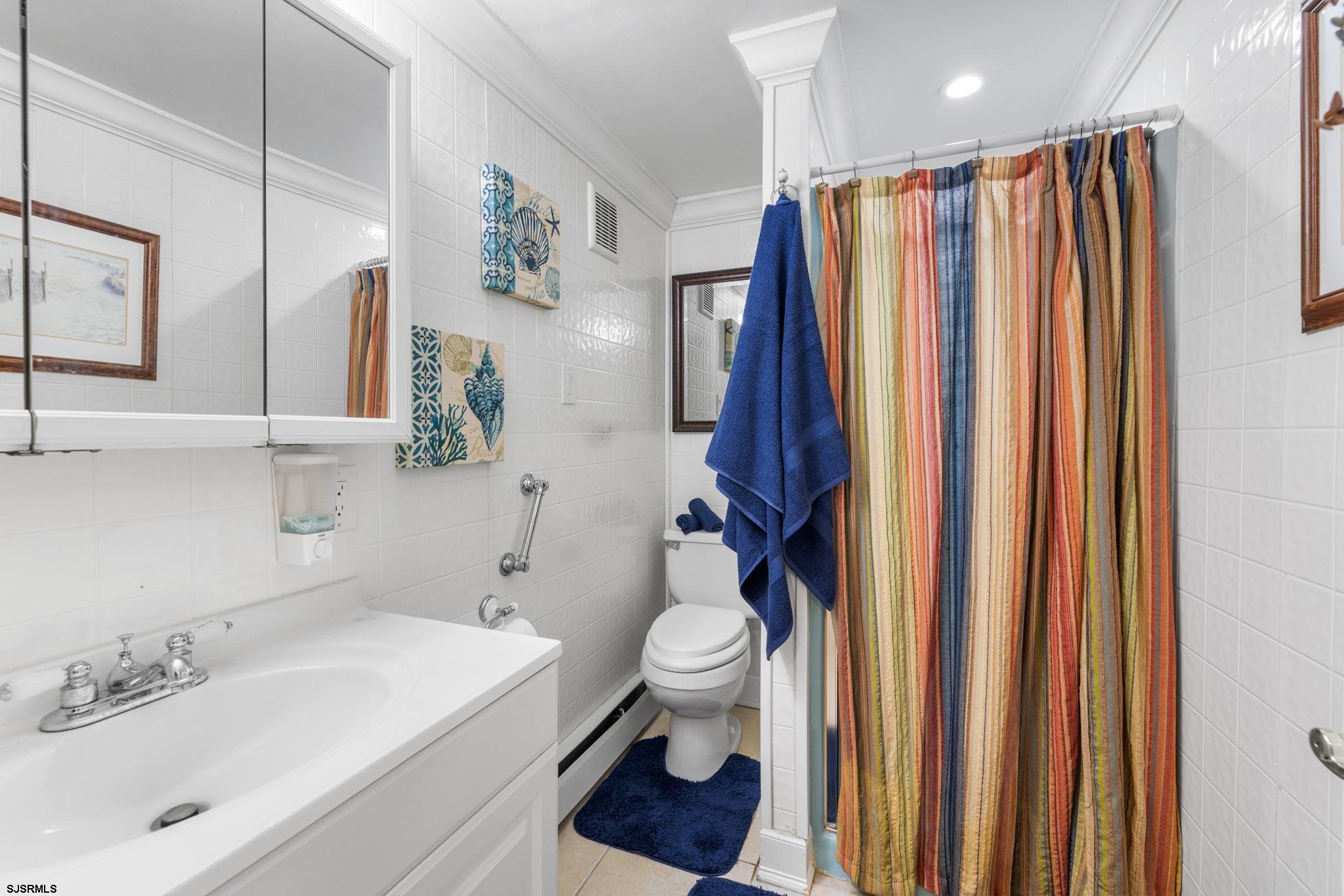 210 Mill Road Absecon, NJ 08201 - Photo 33 of 52 a bathroom with a sink a toilet and shower curtain