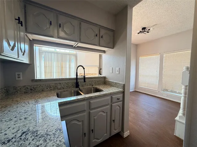a kitchen with sink and cabinets