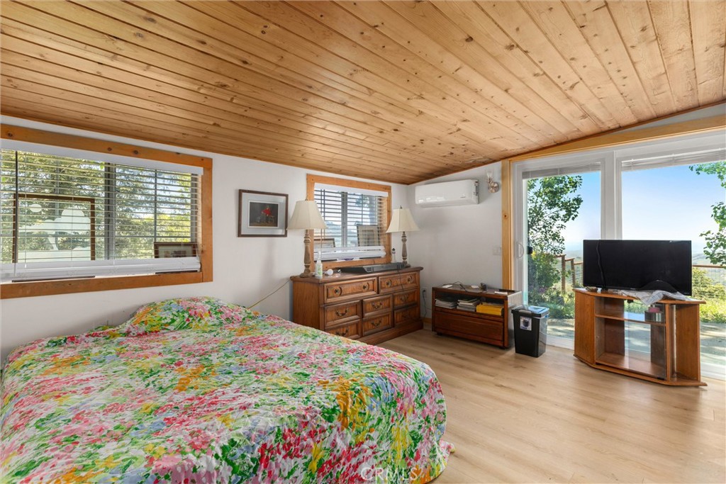 3510 Cypress Mountain Road Templeton, CA 93465 - Photo 14 of 44 a bedroom with a bed and wooden floor