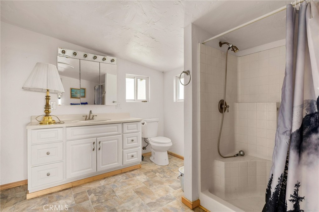 3510 Cypress Mountain Road Templeton, CA 93465 - Photo 15 of 44 a spacious bathroom with a granite countertop sink toilet and shower