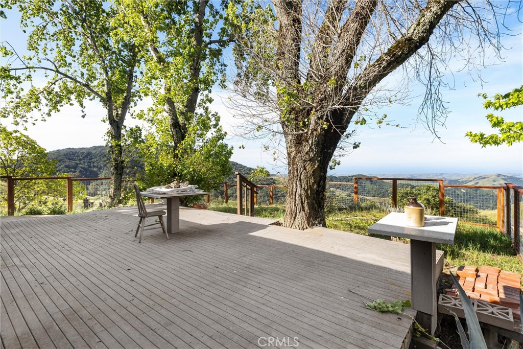 3510 Cypress Mountain Road Templeton, CA 93465 - Photo 37 of 44 a view of a patio with table and chairs with wooden fence and floor