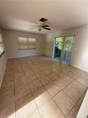 a view of a livingroom with wooden floor and windows