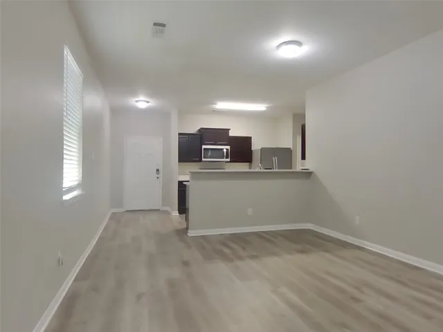 a view of a kitchen with a sink and microwave