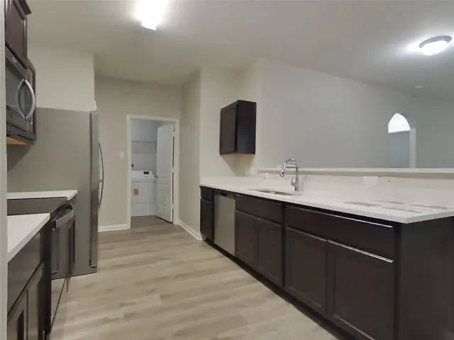 a spacious bathroom with a sink and a mirror
