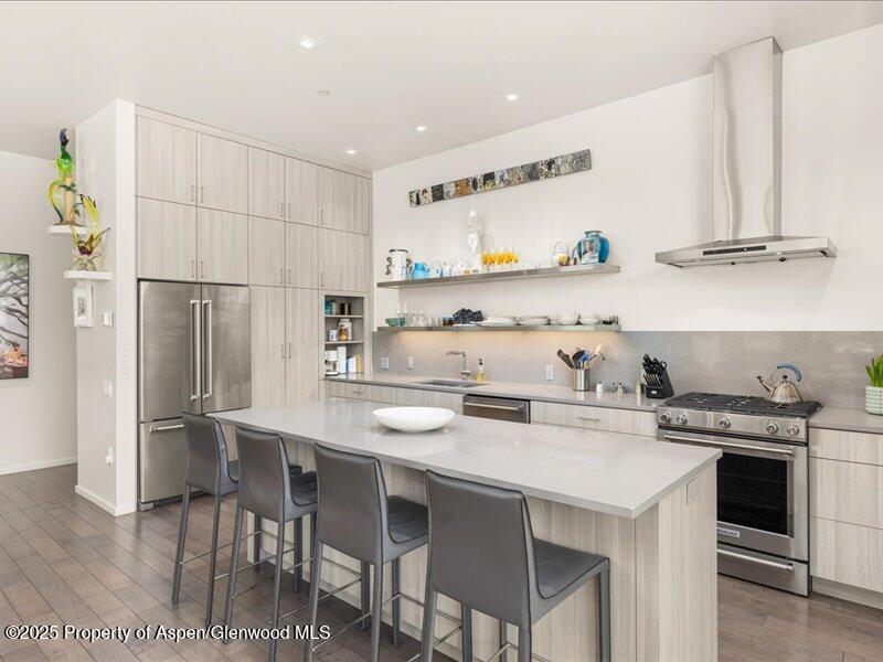 102 Evans Road, Unit 107 Basalt, CO 81621 - Photo 8 of 25 a kitchen with stainless steel appliances a table chairs and a refrigerator