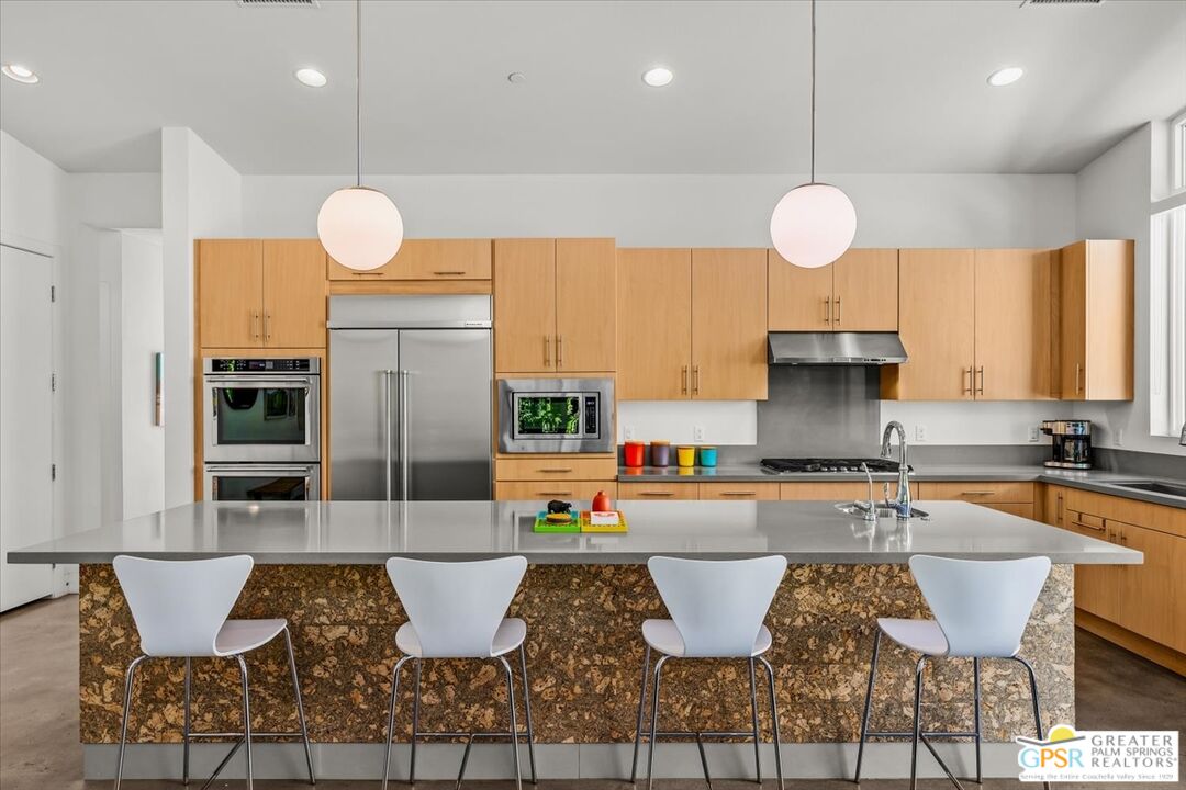 4201 Amber Lane Palm Springs, CA 92262 - Photo 11 of 55 a kitchen with kitchen island granite countertop a sink and a stove